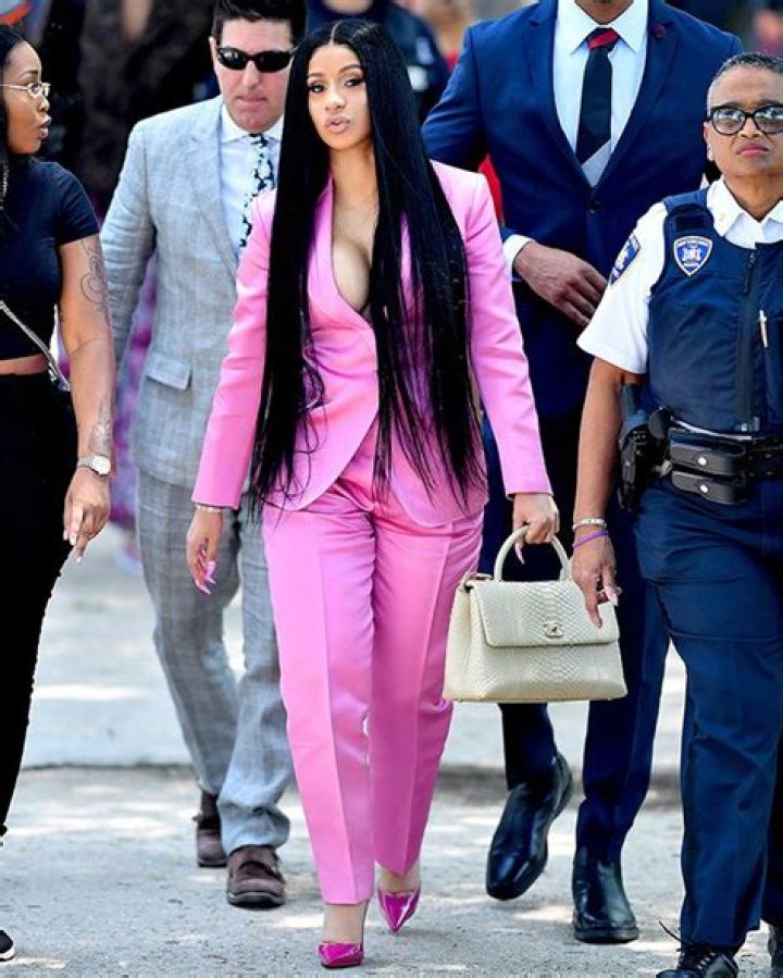 Cardi B Rocks Bright Pink Plunging Suit With Nothing Underneath & Wild Nails For Latest Court Appearance